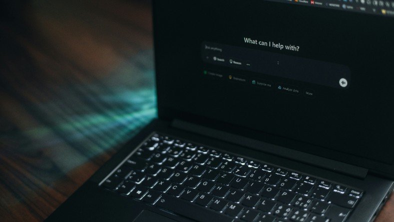A laptop displays an AI search bar.